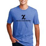 A person wearing a blue t-shirt with a crossed "X" symbol and the text "MAKE YOUR MARX." They are standing with hands in pockets, smiling, and wearing dark jeans.
