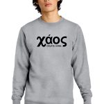 A person wearing a gray sweatshirt with the text "Xáos CREATE SOME." in black lettering stands against a white background. They have medium-length, wavy hair and are looking directly at the camera.