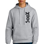 A person with short blonde hair wears a light gray hoodie and blue jeans. The hoodie features the word "Xáos" in black, printed vertically down the left side. The person stands against a white background.