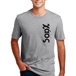 A smiling man wearing a gray t-shirt with the word "Sopx" printed vertically in black. He has short brown hair and is standing with his hands in the pockets of his blue jeans against a white background.