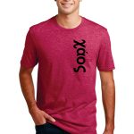 A person wearing a red, short-sleeved t-shirt with the text "Soozy" printed vertically in black on the left side. They are also wearing blue jeans and standing against a plain white background, smiling with one hand in their pocket.