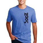 Man wearing a blue T-shirt with "sólo" written vertically in black on the side, standing and smiling against a white background.