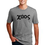 Man wearing a gray T-shirt with the word "χάος" in black Greek letters on the front. He is standing with one hand in his pocket, smiling.