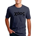 A person wearing a dark blue T-shirt with the word "χάος" printed in black on the front. They have short dark hair and are standing with hands in their jeans pockets against a plain white background.