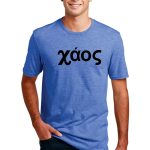 A person wearing a blue T-shirt stands with hands in pockets. The T-shirt features the word "χάος" in bold black letters. The person is smiling and posing against a plain white background.